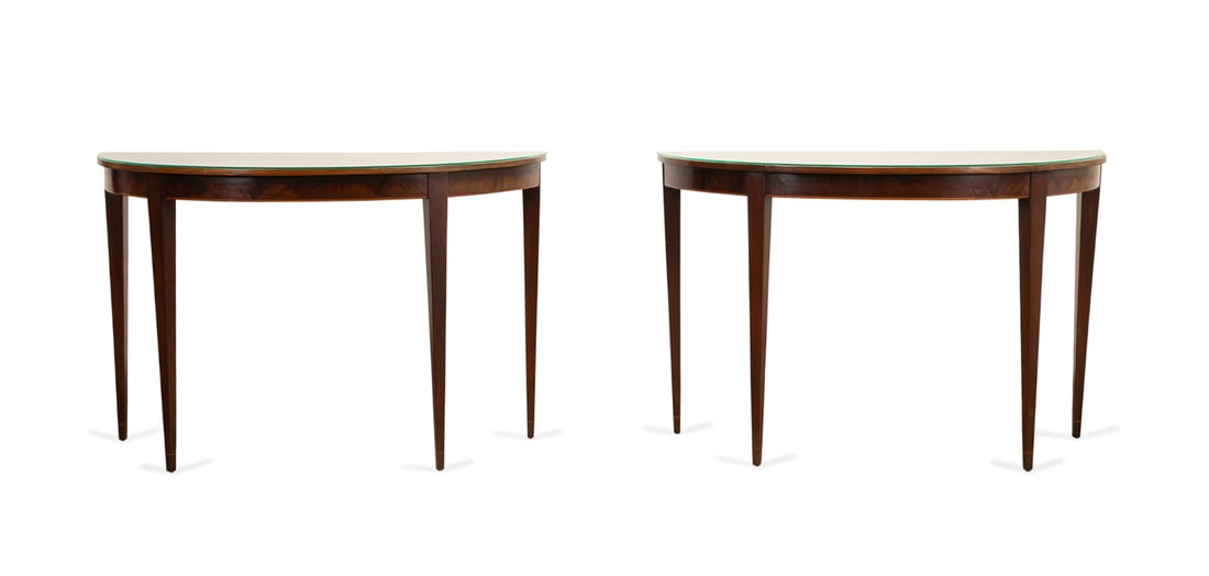PAIR OF HEPPLEWHITE STYLE MAHOGANY CONSOLES: American first half 20th century. Pair of mahogany and mahogany veneer inlaid demilune console tables in the George III Hepplewhite taste, each having an overhanging top with glass top, and rising on