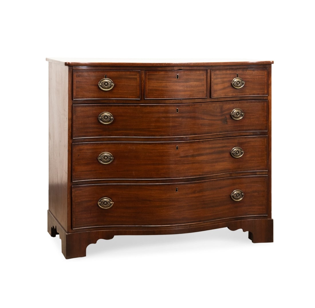GEORGIAN STYLE MAHOGANY 6-DRAWER CHEST: English, late 19th to early 20th century. Mahogany and mahogany veneer inlaid serpentine chest in the Georgian taste, having an overhanging top, 6-drawers, and rising on bracket feet, apparently unmar