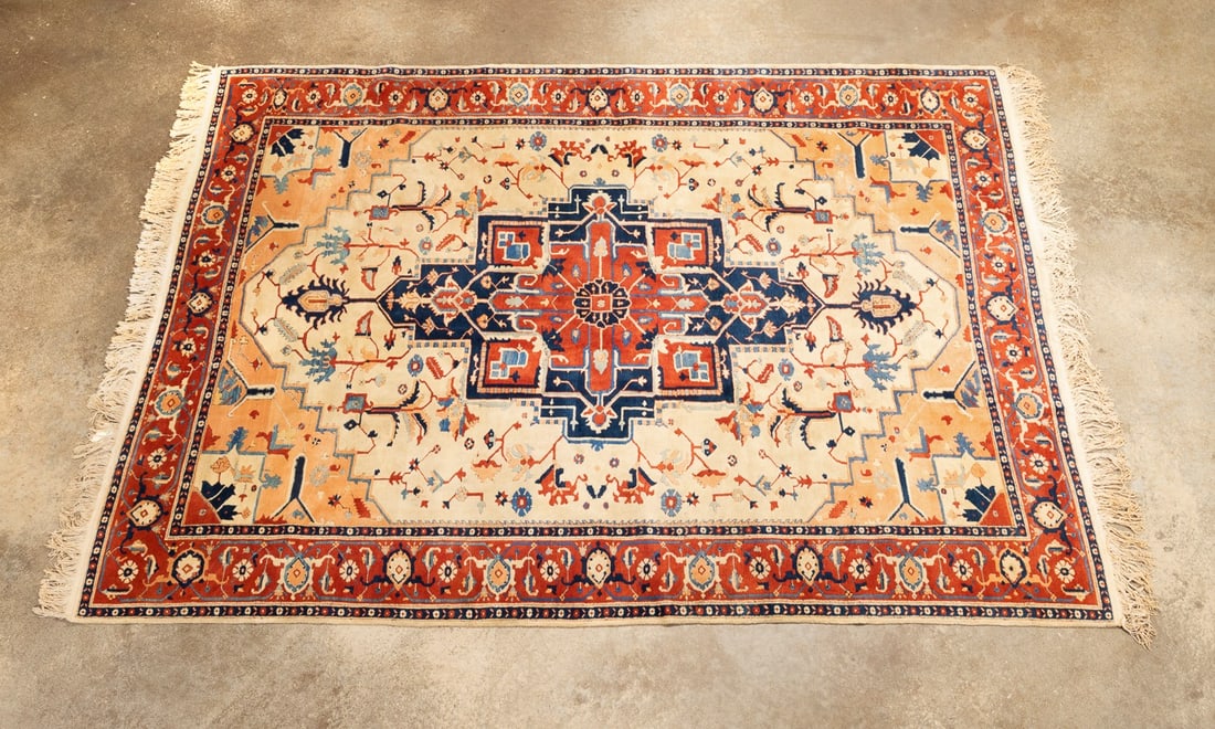 LARGE INDIAN HERIZ HAND-KNOTTED RUG: Indian, 20th century. Large hand-knotted Heriz rug decorated in red, bone, salmon, and navy blue. Apparently unsigned. Approximate dimensions: l. 11'3', w. 8'