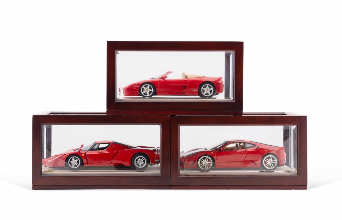 3 HOT WHEEL1/8 SCALE FERRARIS W/ DISPLAY CASES: Three Hot Wheels 1/8 scale Ferrari die-cast cars, including an F-355, F-430, and F-140 Enzo, all displayed in Bombay Company wood and beveled glass cases. Provenance: Private Collection, Atlanta, GA.