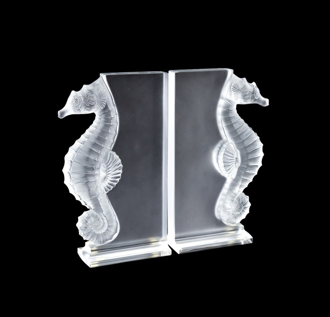 LALIQUE, PAIR OF 'POSEIDON' SEAHORSE BOOKENDS: Lalique (French, founded 1888), contemporary. Pair of colorless "Poseidon" crystal bookends, acid etched "Lalique France" to lower back edge. Provenance: Private Collection of an Esteemed Gentleman, A