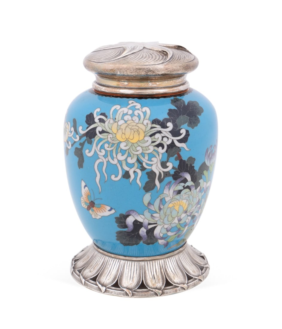 ARTS & CRAFTS STERLING MOUNTED CLOISONNE URN: Shreve & Co. (American (San Francisco), founded 1852). Arts and Crafts sterling mounted cloisonne urn, having a swirling floral pattern top and pierced leaf pattern base, appropriately marked. Provena