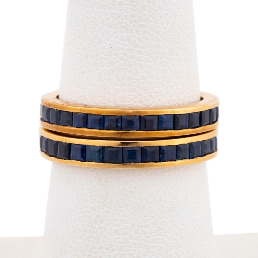 TWO BLUE SAPPHIRE 14K YELLOW GOLD ETERNITY RINGS: Pair of blue sapphire stackable eternity band rings in 14k yellow gold, with square channel set sapphires. Both stamped 14k. Approximate measurements: US ring size 6.25; total weight 5.2 grams. Note: