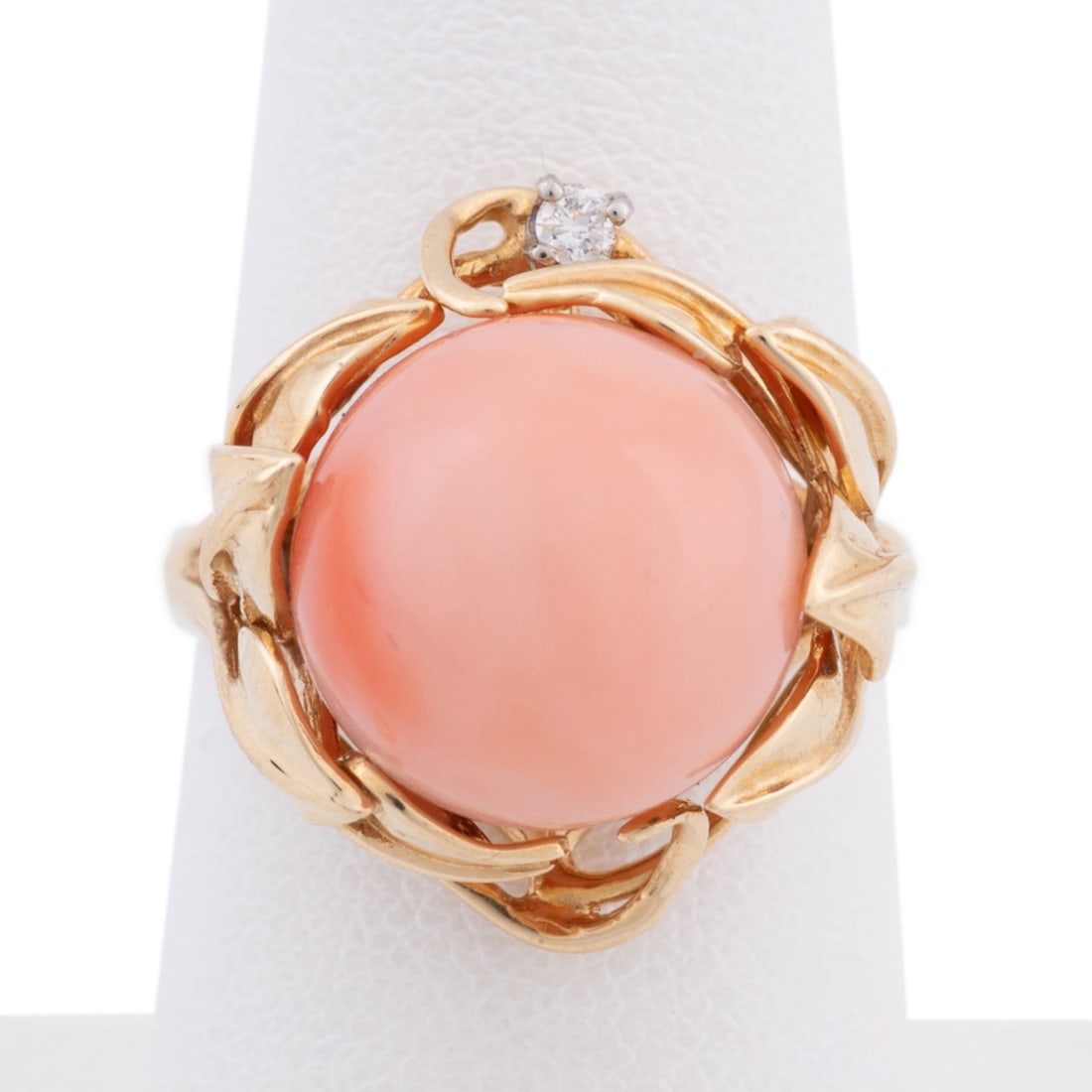 14K CORAL & DIAMOND YELLOW GOLD RING: Coral and yellow gold diamond ring featuring an approximate 12.7mm spherical pink coral bead and brilliant cut diamond accent (approximately 0.04ct, I-1 clarity, and H color). Approximate measurements
