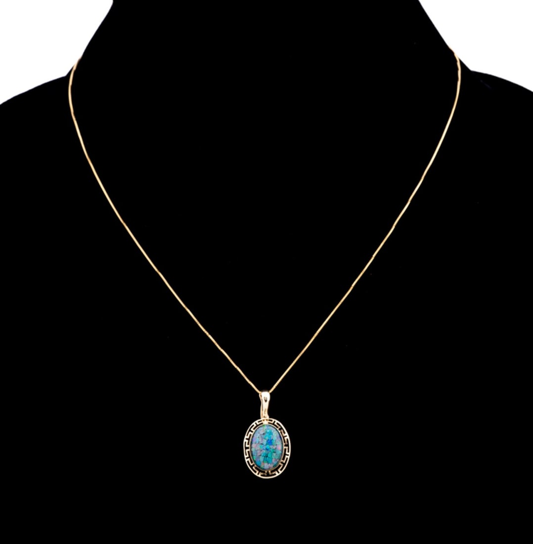 MOSAIC OPAL & 14K YELLOW GOLD NECKLACE: 14k yellow gold opal triplet pendant featuring an opal triplet composed of pieces of opal set in a mosaic pattern (approximately 14 x 10mm). With yellow gold chain. Chain and pendant marked "14k". App