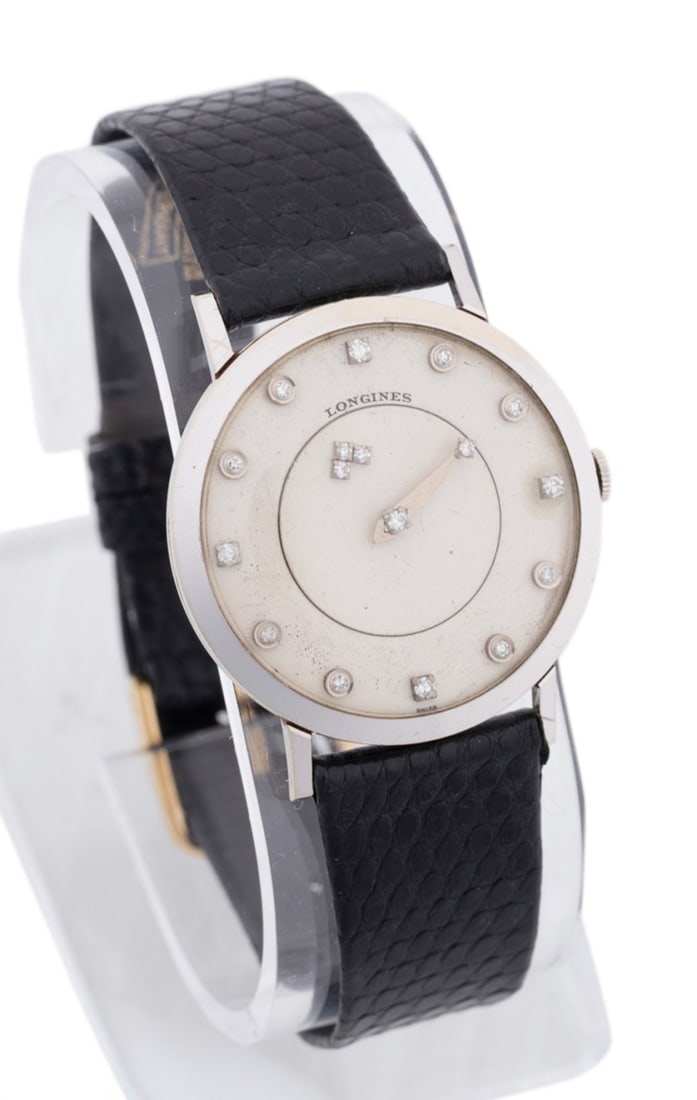 LADIES LONGINES MYSTERY DIAL DIAMOND & 14K WATCH: Longines 14k white gold diamond strap watch featuring a manual wind jeweled movement, off white dials, diamond accented hour/hour indicator/hands featuring (17) round brilliant cut diamonds (approxima