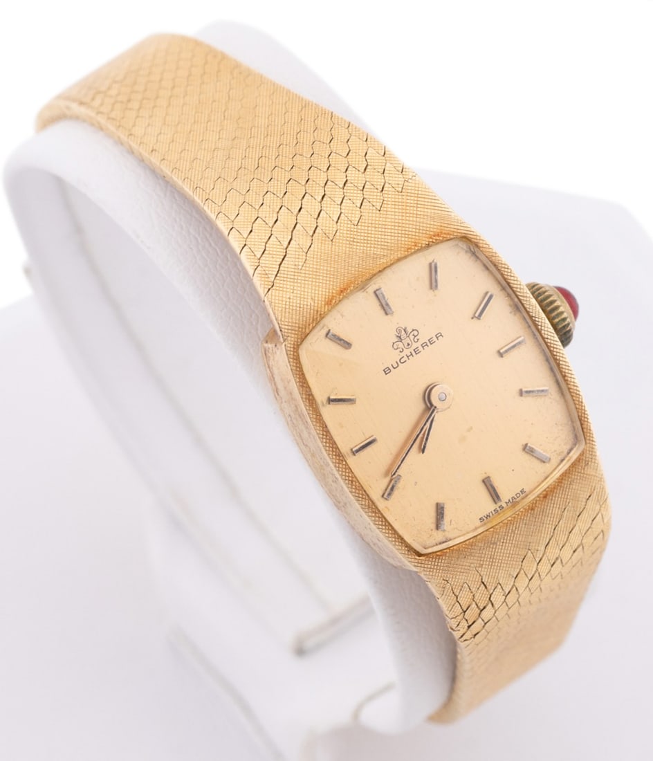 LADIES' VINTAGE BUCHERER 18K YG BRACELET WATCH: Bucherer Ltd (Swiss, founded 1888). Vintage ladies' wrist watch in 18k yellow gold, with manual wind movement, gold dial having gold hour markers, and an 18k yellow gold mesh bracelet. Several makers'