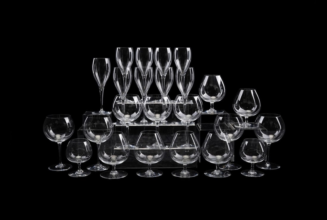 BACCARAT, 24 PIECES OF ASSORTED CRYSTAL STEMWARE: Baccarat (French, founded 1764), 20th century. Assortment of 24 pieces of colorless crystal stemware comprising, 9 "St. Remy" water goblets (8.5"), 7 "Tastevin" burgundy wine glasses (7.5") and in "Pe