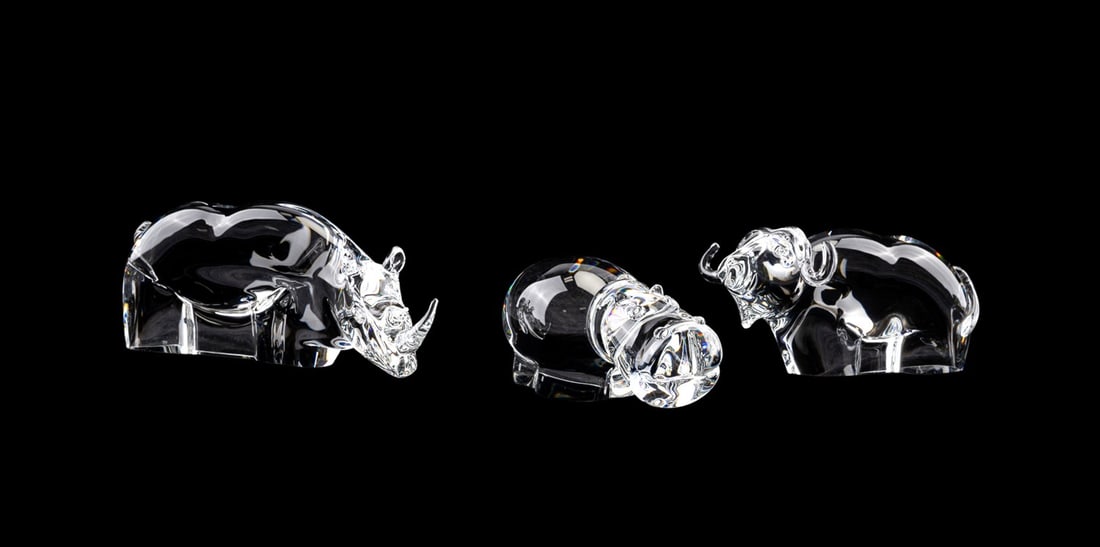 STEUBEN, THREE ANIMALS, INCLUDING A WATER BUFFALO: Steuben (American, founded 1903), late 20th to early 21st century. Collection of three colorless crystal animal figures comprising, a rhinoceros, a water buffalo or water ox, and a hippopotamus, all a