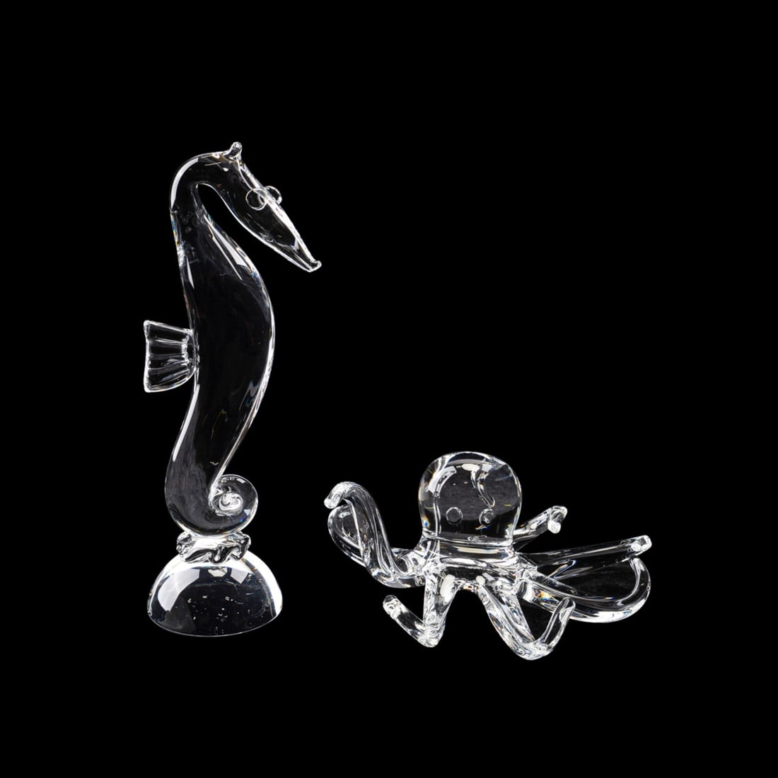 STEUBEN, SEAHORSE AND OCTOPUS FIGURES: Steuben (American, founded 1903). Group of two colorless crystal sea life figures comprising a Lloyd D. Atkins (American, 1922-2002) designed seahorse and an Taf Lebel Schaefer (American, born 1950) d