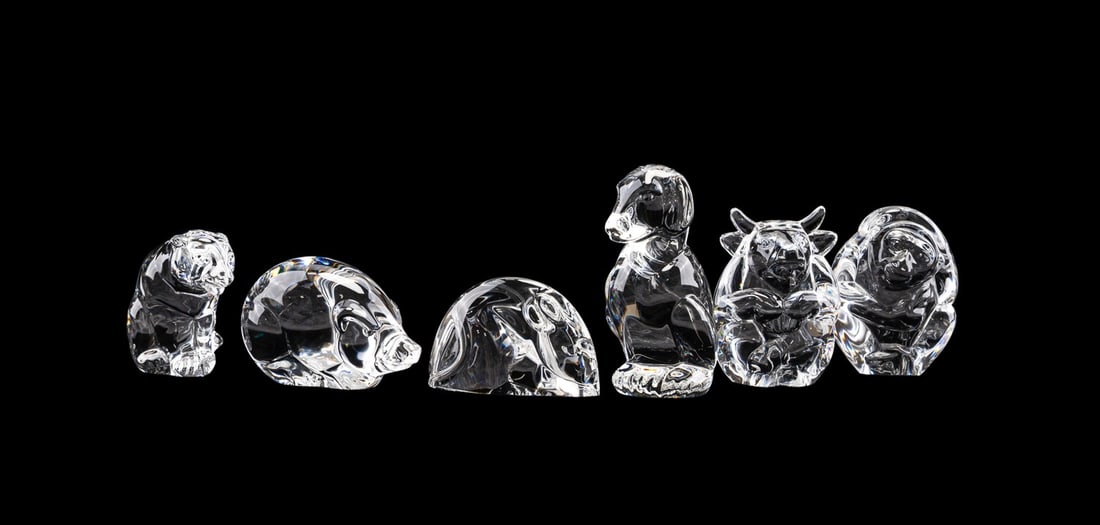 STEUBEN, COLLECTION OF SIX ANIMAL HAND COOLERS: Steuben (American, founded 1903). Collection of six colorless glass animal hand coolers comprising, a bull (h. 2.75"), a dog (h. 3"), a monkey (h. 2.5"), a pig (h. 2"), a tiger (h. 2"), and a woodland