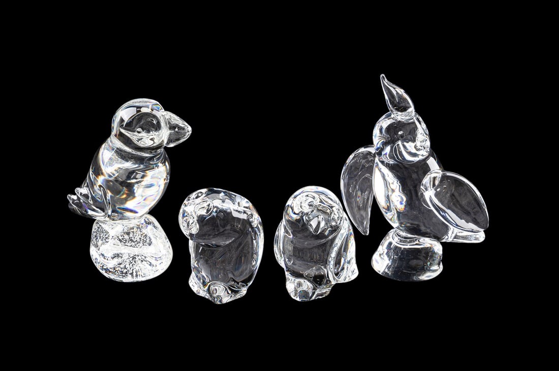 STEUBEN, ASSORTMENT OF FOUR LARGE BIRD FIGURES: Steuben (American, founded 1903). Assortment of four large colorless glass bird figures including a puffin and a pair of owls, appropriately marked Approximate measurements: largest h. 7.5", w. 5.5",
