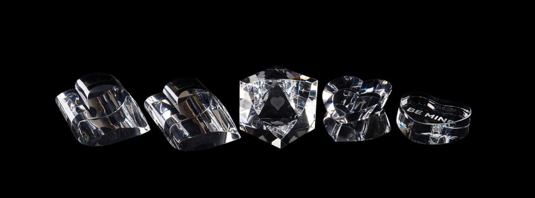 STEUBEN, FIVE HEART HANDBOOKENDS OR PAPERWEIGHTS: Steuben (American, founded 1903), late 20th to early 21st century. Collection of five colorless glass heart-form bookends, hand coolers or paperweights, all appropriately marked. Approximate measureme