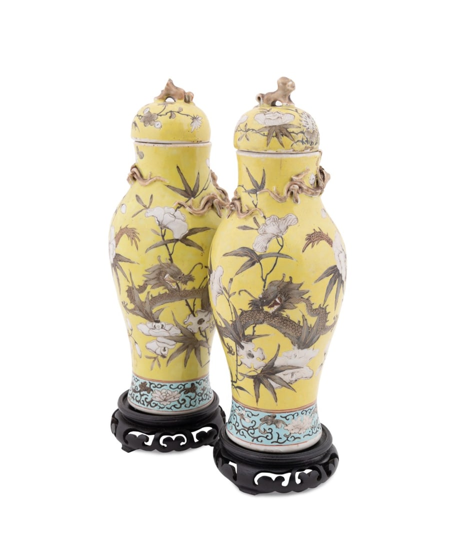 PAIR, CHINESE FAMILLE JAUNE LIDDED URNS: Chinese, 19th century. Pair of porcelain Famille Jaune vases with lids decorated with gilt dragons chasing the fiery pearl of wisdom and chrysanthemums, apparently unmarked. Accompanied by wooden stan