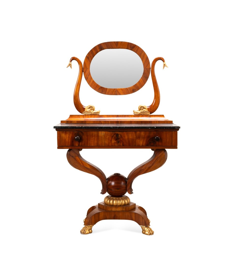 19TH C. CONTINENTAL EMPIRE DRESSING TABLE: Continental, likely Northern European, 19th century. Empire parcel gilt mahogany veneer dressing table, having an oval mirror with dolphin supports, Belgian bluestone top, single drawer, volute suppor