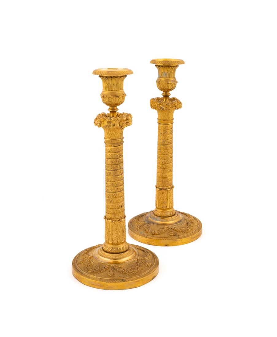 PAIR OF EMPIRE ORMOLU CANDLESTICKS, 19TH C.: Manner Gerard-Jean Galle (French, 1759-1815); French, 19th century. Pair of gilt bronze ormolu Empire / Restoration candlesticks, each having an acanthus sconce, floral basket capital on a shaft model