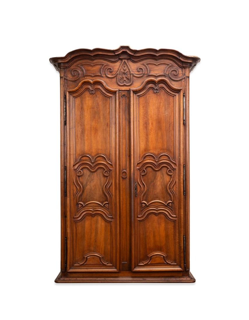 19TH C. LARGE FRENCH PROVINCIAL WALNUT ARMOIRE: French, possibly Lyon region, 19th century or earlier. Large provincial walnut armoire in the Louis XIV / Regence taste, having a shaped cornice, frieze with applied molding and shell detail, double p