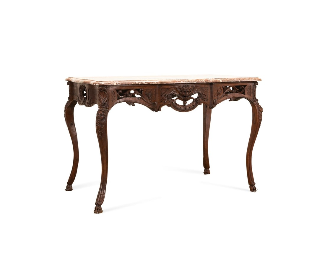 19TH C. REGENCE/LOUIS XV REVIVAL SALON TABLE: Continental, possibly French, 19th century. Regence / Louis XV Revival walnut salon table, having a marble top, diapered apron, figural carving, and rising on cabriole legs with paw feet, apparently u