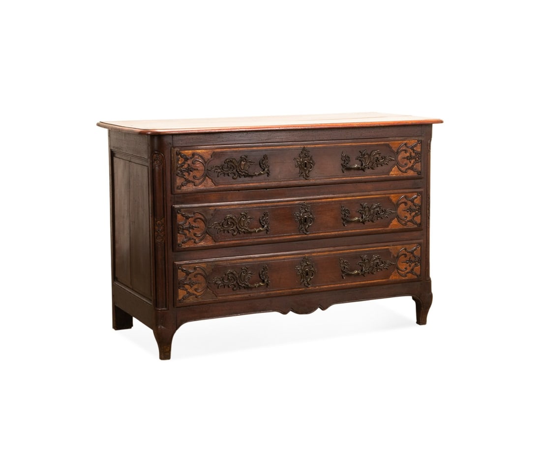 19TH C. PROVINCIAL LOUIS XV STYLE WALNUT COMMODE: French, 19th century. Provincial walnut commode in the Louis XV taste, having an overhanging top, three foliate carved drawers, and rising on front cabriole legs, apparently unmarked. Approximate dime