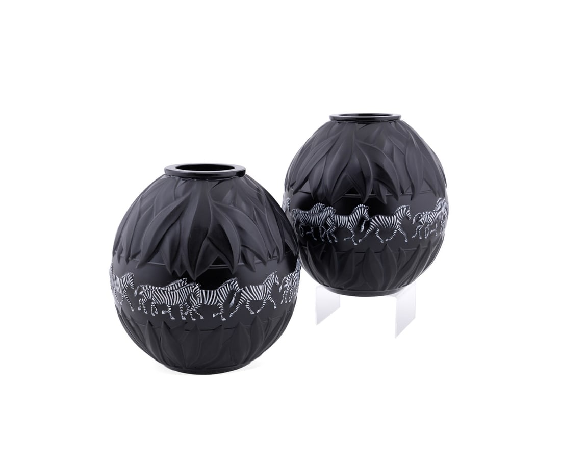 LALIQUE, PAIR OF 'TANZANIA' ZEBRA VASES: Lalique (French, founded 1888), circa 1991. Pair of black "Tanzania" vases, executed in matte black glass with white enamel accents, of globular form, with low relief molded leaves framing a center ba