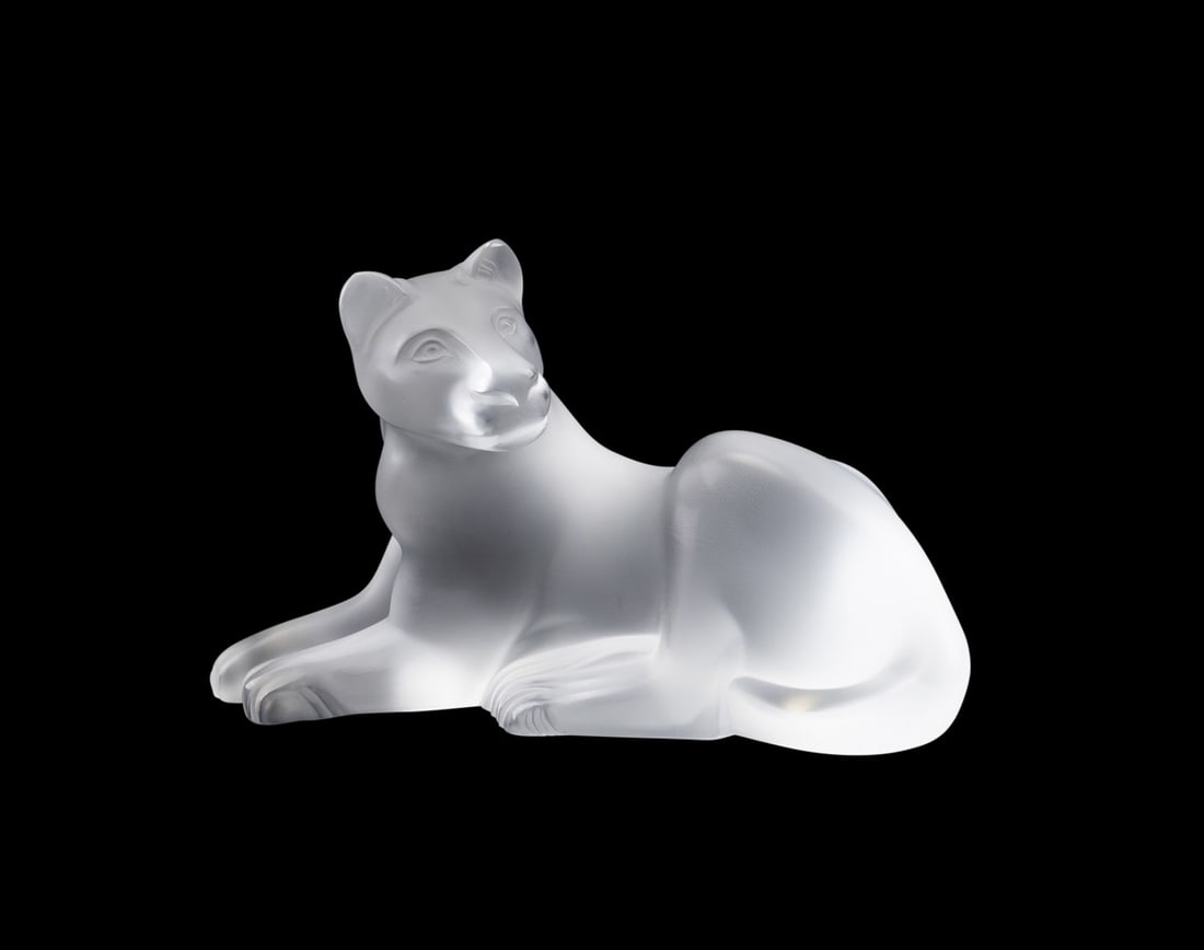 LALIQUE, 'SIMBA' RECLINING LIONESS FIGURE: Marie-Claude Lalique (French, 1935-2003) for Lalique (French, founded 1888). Colorless and frosted crystal "Simba" reclining lioness figure, acid-etched signature "Lalique France" to bottom under righ