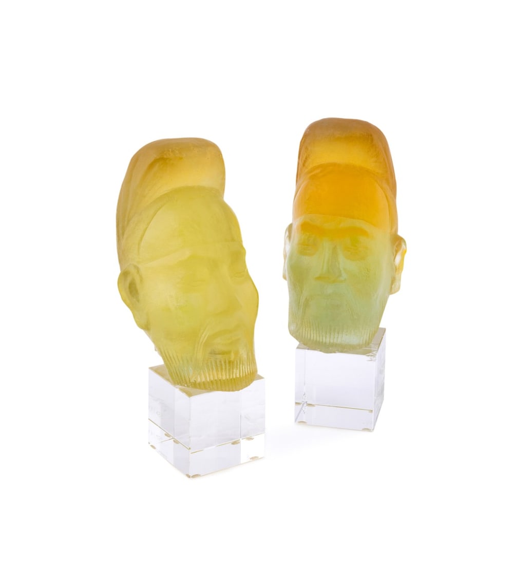DAUM, PAIR OF LIMITED EDITION 'TAOIST SAGE' HEADS: Daum (French, founded 1878). Pair of limited edition "Taoist Sage" pate de verre yellow and amber head on colorless crystal base, acid-etched signature "Daum France" and numbered "47/488" and "82/488"