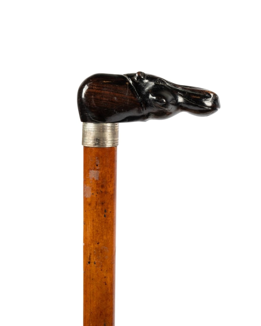 19TH C. ENGLISH VETERINARIAN CANE WITH THERMOMETER: English, circa 1850. Veterinarian walking cane with carved mahogany hippopotamus head handle supported by silver collar, Malacca shaft containing thermometer encased in solid brass cylinder with brass