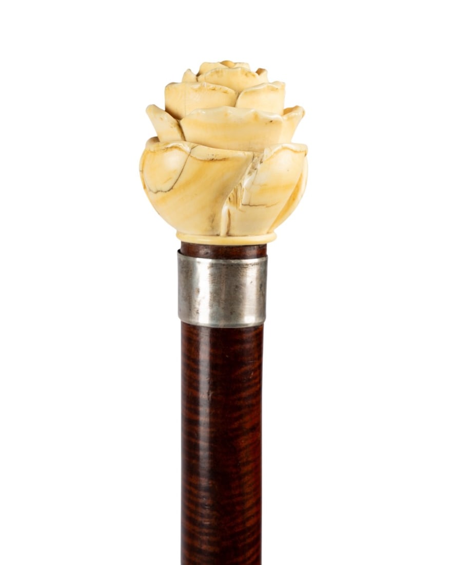 ENGLISH ROSE BLOSSOM HANDLE WALKING CANE, C. 1875: English, circa 1875. Walking cane with carved bone rose blossom handle, sterling silver collar with London hallmark, oak shaft added in 1988, and iron ferrule. Approximate measurements: handle: 2.5";