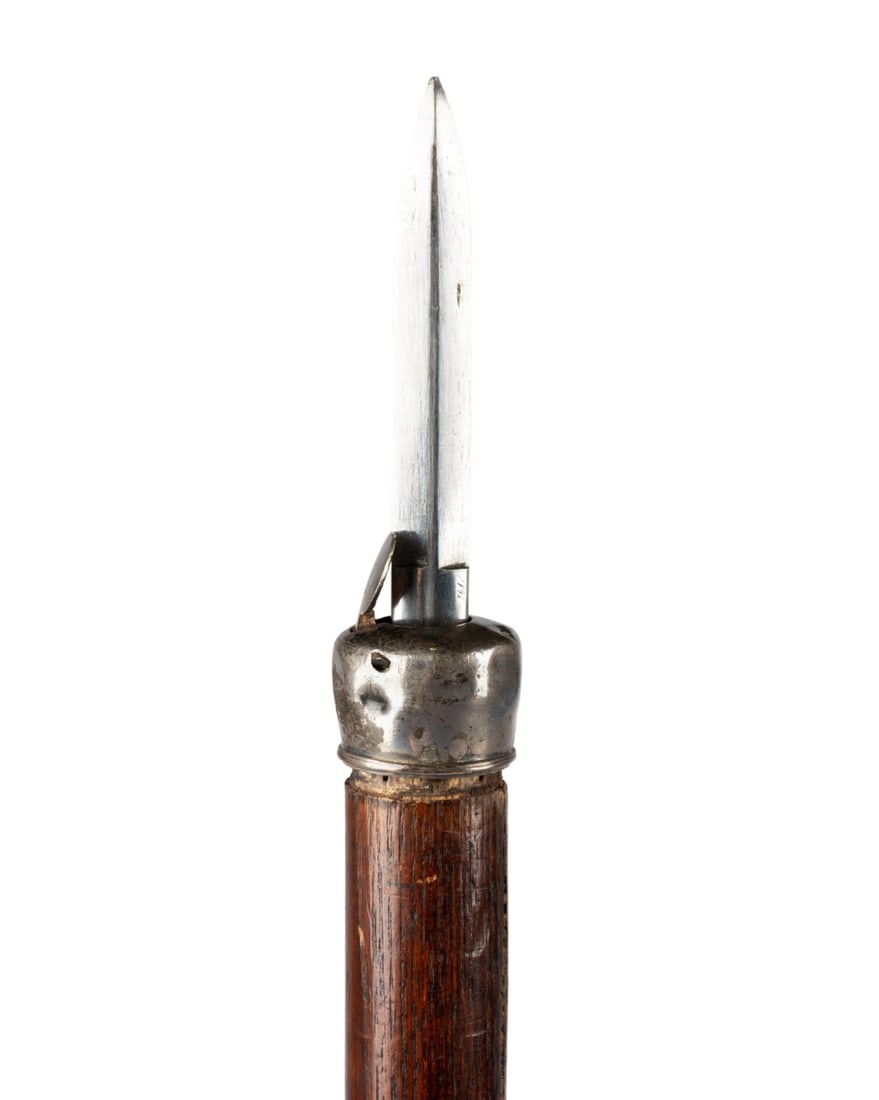 FRENCH FLICK STICK HIDDEN BLADE WALKING CANE: French, circa 1870. Flick stick walking cane with silver knob handle with hinged silver disk concealing 6" knife, finely turned oak shaft with slight taper, and brass ferrule with pointed steel tip. A