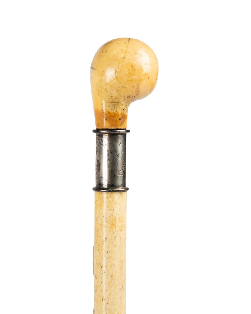 19TH C. GERMAN NAUTICAL BONE CANE: German, circa 1860. Walking cane with carved and polished handle, silver collar engraved with initials "P.B." and skull and crossbones, carved and polished bone shaft, and metal ferrule. Approximate m