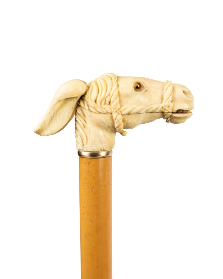 19TH C. CARVED MULE DOUBLE AUTOMATA HANDLE CANE: Continental, circa 1880. Automata walking cane with large carved mule handle with glass eyes, long ears, and rope halter, operating lever to open mouth revealing teeth and ears, tan Malacca wood shaft