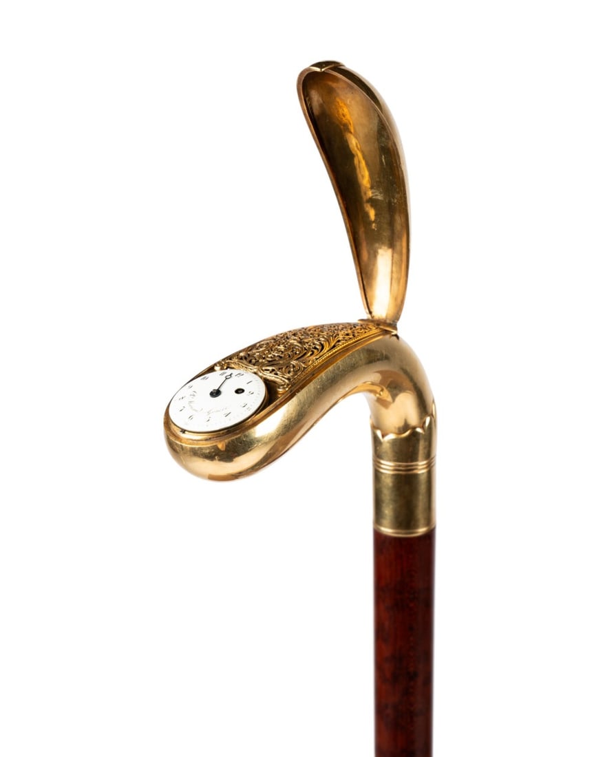19TH C. SWISS MORICAND 18K YG WATCH HANDLE CANE: Swiss, circa 1840. Walking cane with 18k yellow gold handle containing Ch. Moricand watch under gold lid and adjacent pierced lid opening to snuff box, connected to snakewood shaft with bone ferrule.