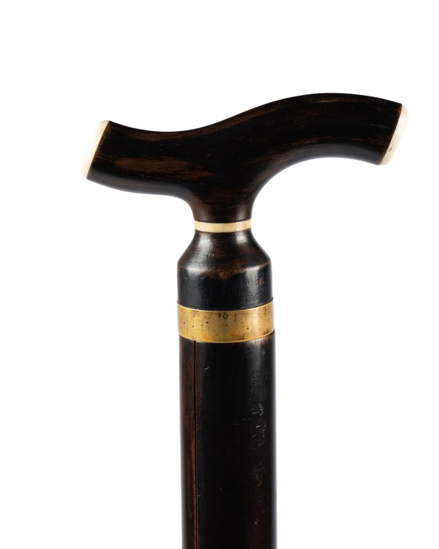 GERMAN VIOLIN MUSICAL CANE, C. 1850: German, circa 1850. Violin walking cane with walnut handle capped with bone, thin bone collar below brass ring fitting, removable handle revealing chamber with 15.5" horsehair bow with bone mounts