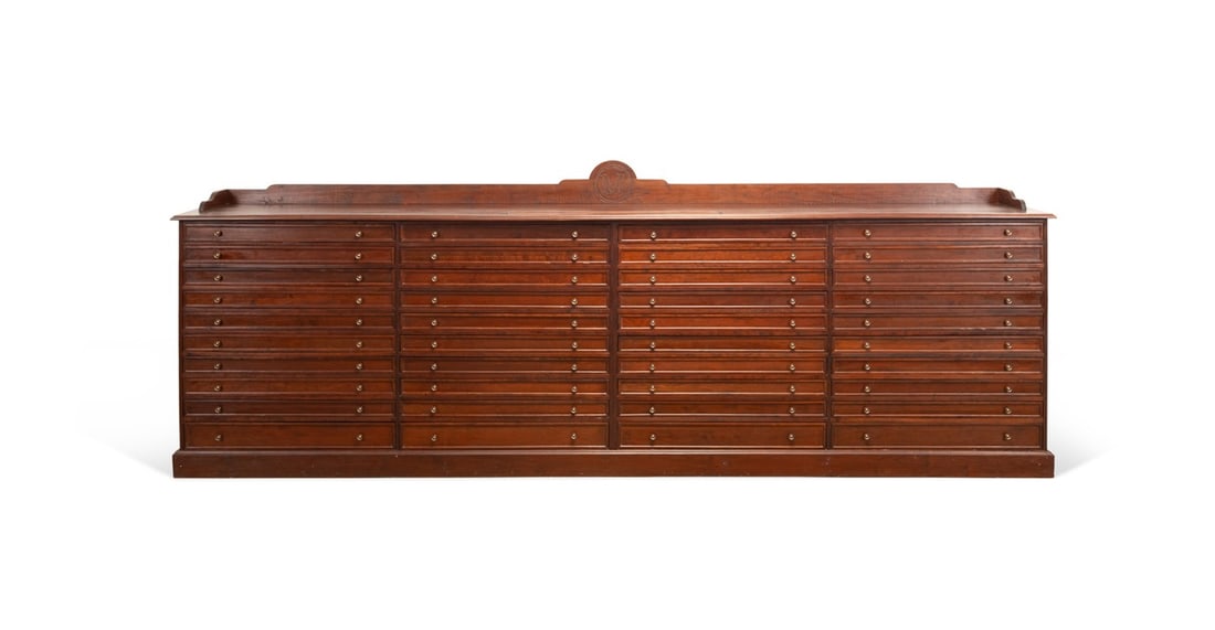 MONUMENTAL SOLID CHERRY CANE STORAGE CABINET: Monumental custom built solid cherry cabinet in four parts fitted with 40 felt-lined dovetailed drawers, carved crown centered with letter "M", designed for housing a large cane collection and