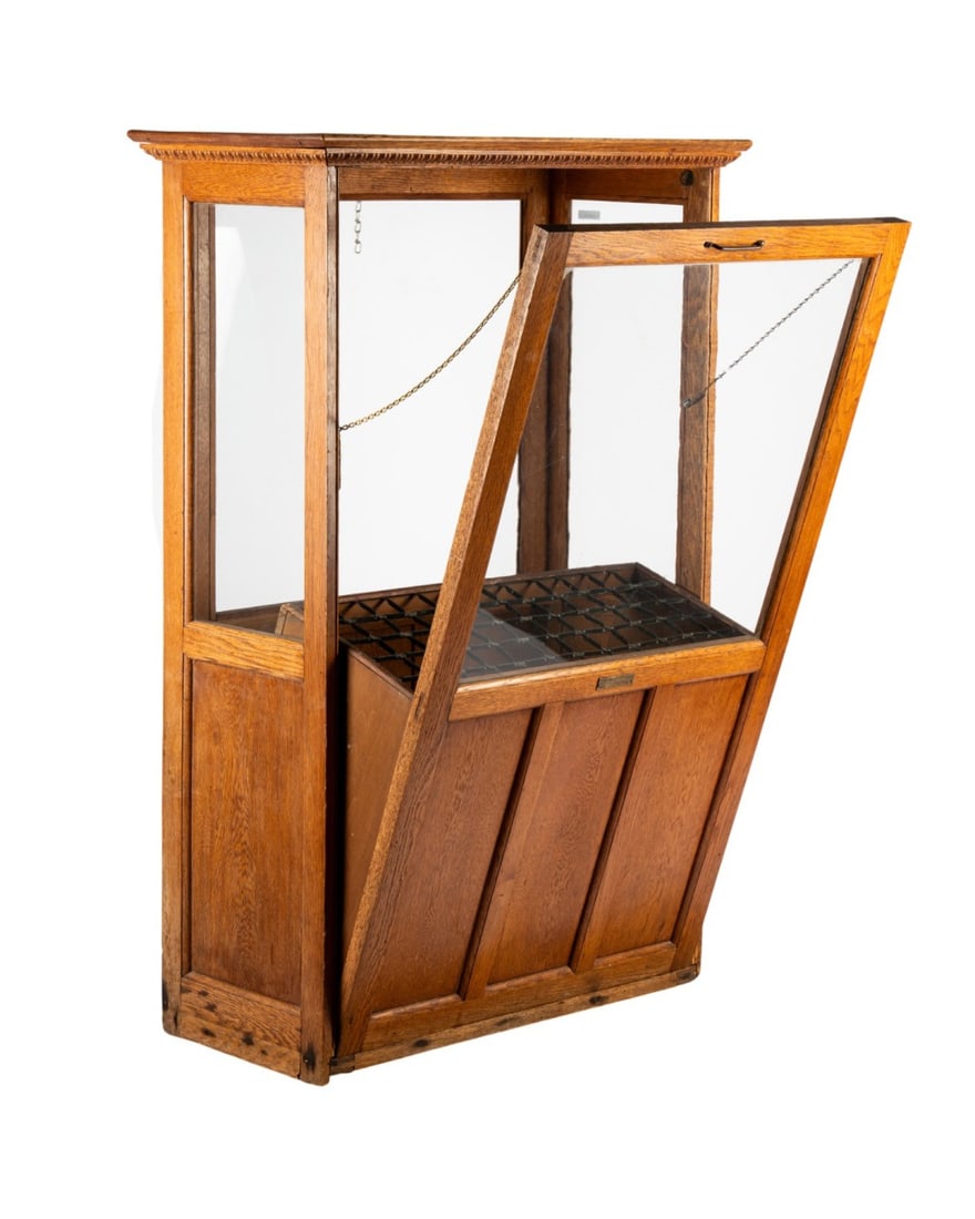 19TH C. AMERICAN OAK WALKING CANE DISPLAY CASE: American, circa 1890, A.N. Russell & Sons (American, 1871-1932). Oak cane display case with glass on all four sides, front door tilting open for access, designed to hold 60 canes, with metal plaque