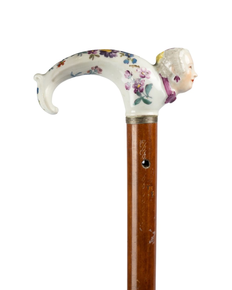 MEISSEN 18TH C. PORCELAIN WALKING CANE: German, late 18th century, Meissen (German, founded 1705). Walking cane with porcelain handle modeled as a woman?s face and decorated with flowers and botanical motifs, fitted with a metal collar, and