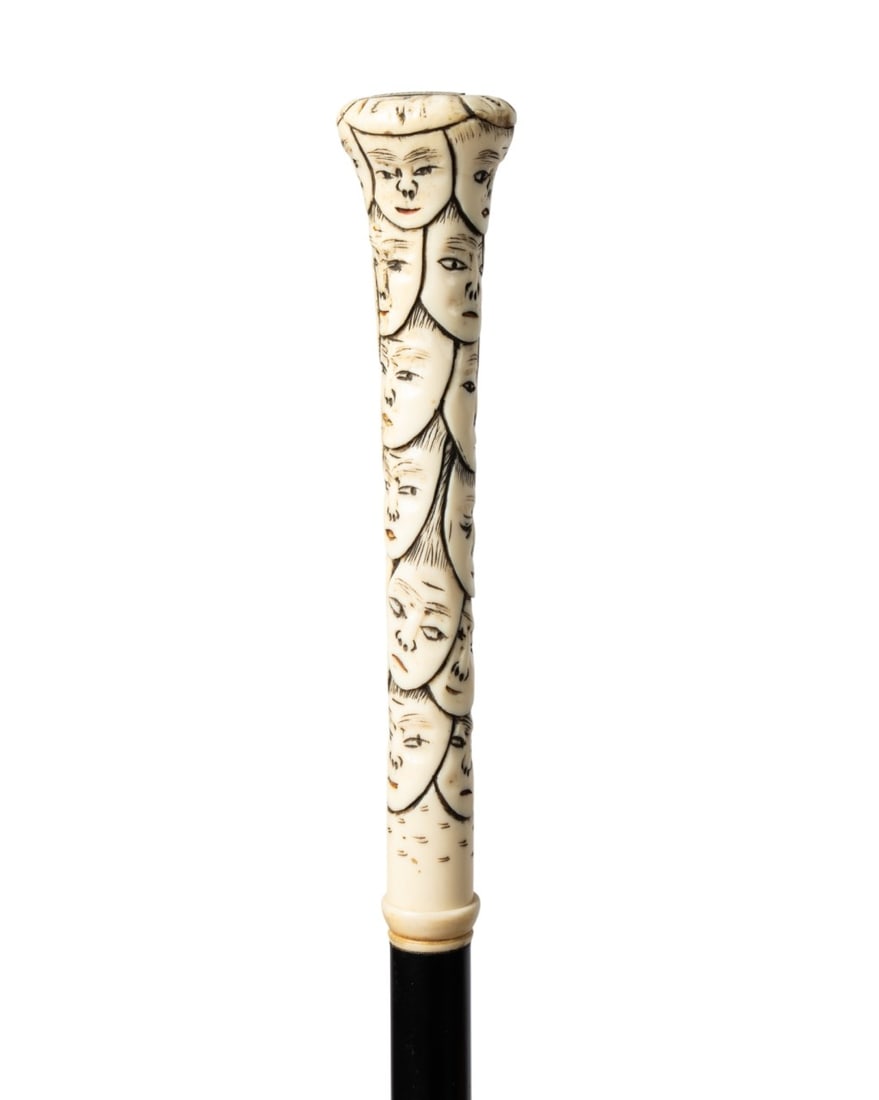 19TH C. JAPANESE 1000 FACES WALKING CANE: Japanese, circa 1890. Walking cane with intricately carved bone "1000 Faces" handle, ebonized hardwood shaft, and black horn ferrule. Approximate measurements: length: 36.5"