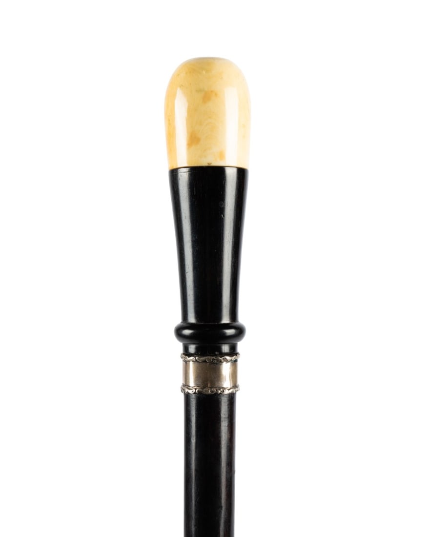 19TH C. ENGLISH EYE DOCTOR'S GADGET CANE: English, circa 1890. Eye doctor gadget cane with turned knob handle on polished hardwood, sterling silver collar, and stained hardwood shaft terminating in a metal ferrule, with top knob unscrewing to