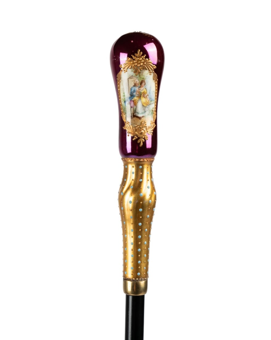 19TH C. BOHEMIAN GLASS WALKING CANE: Austrian / Hungarian, circa 1870. Walking cane with deep pink Bohemian glass handle decorated with a hand-painted courting scene, gilt ornament and turquoise enamel accents, supported by a brass