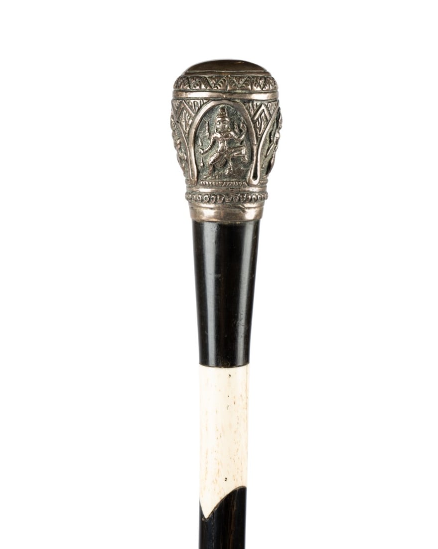 19TH C. ANGLO-INDIAN EBONY & BONE WALKING CANE: Indian, circa 1860. Walking cane with rounded knob handle with panels depicting various gods, interlocking ebony and bone barber pole style shaft, and no ferrule. Approximate measurements: length: