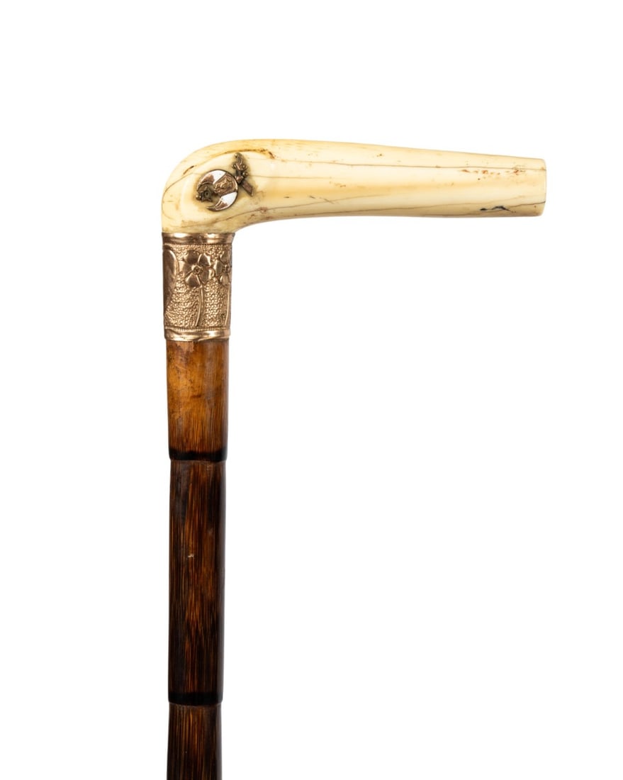 AMERICAN SHRINER MASONIC CANE, C. 1930: American, circa 1930. Shriner Masonic walking cane with L-shaped carved bone handle with double-headed metal eagle and enamel Masonic symbol in crook, rolled gold collar, partridge wood shaft, and met