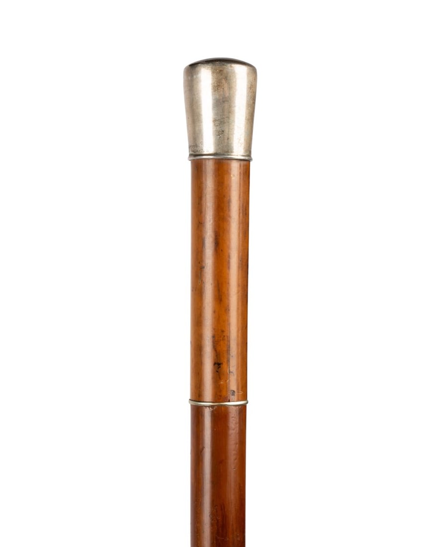 ENGLISH SWORD CANE WITH SILVER HANDLE, C. 1870: English, circa 1870. Cane sword with silver knob handle marked at bottom, Malacca shaft, metal ferrule, flick out quillion mechanism with twist action lock, full length Toledo sword with guards swingi