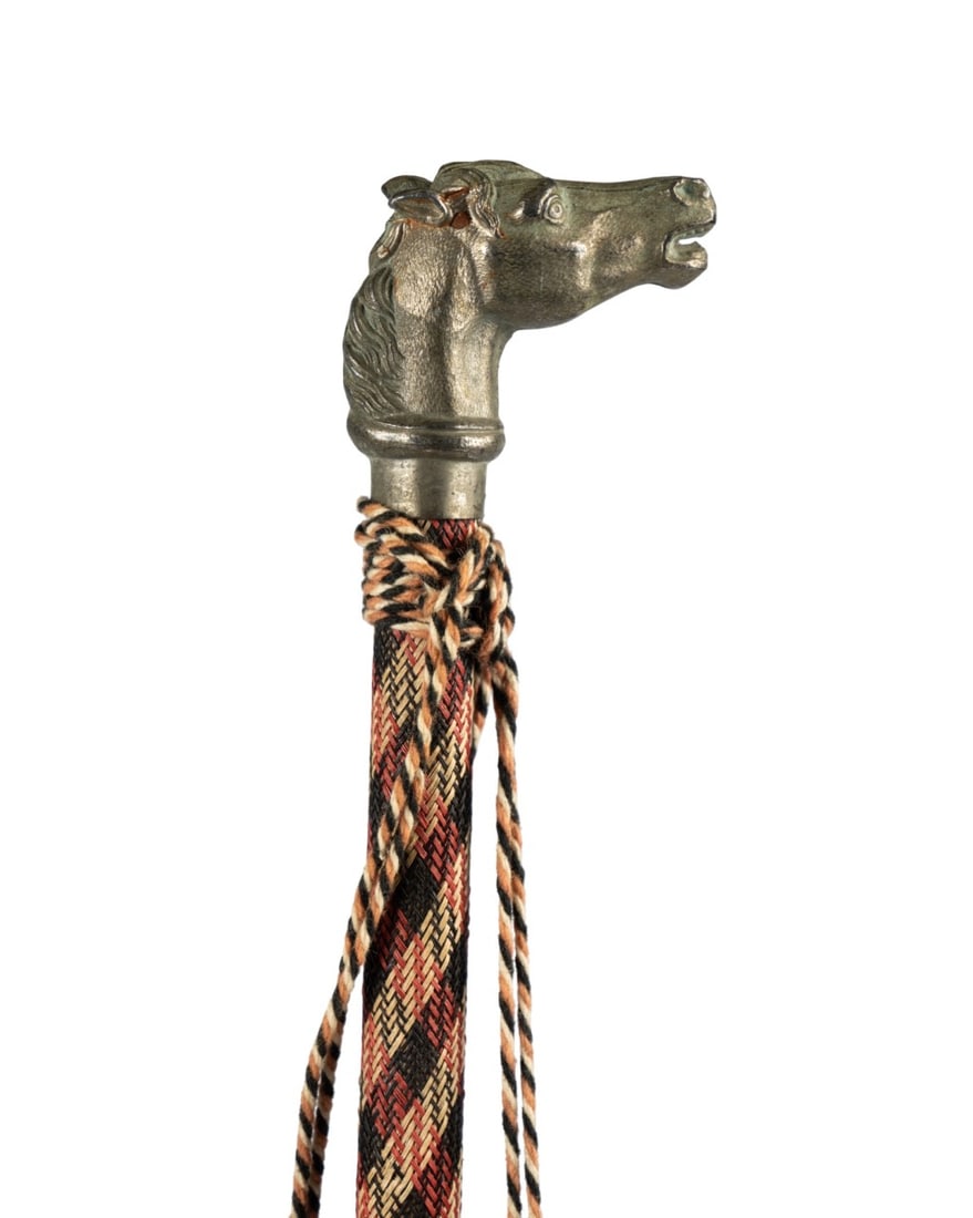 WWI GERMAN MILITARY RESERVISTENSTOCK CANE: German, circa 1918. World War I German military Reservistenstock cane with metal horse head handle of zinc and iron, wood shaft covered in plaid fabric, metal ferrule, and two tassels on a string at t