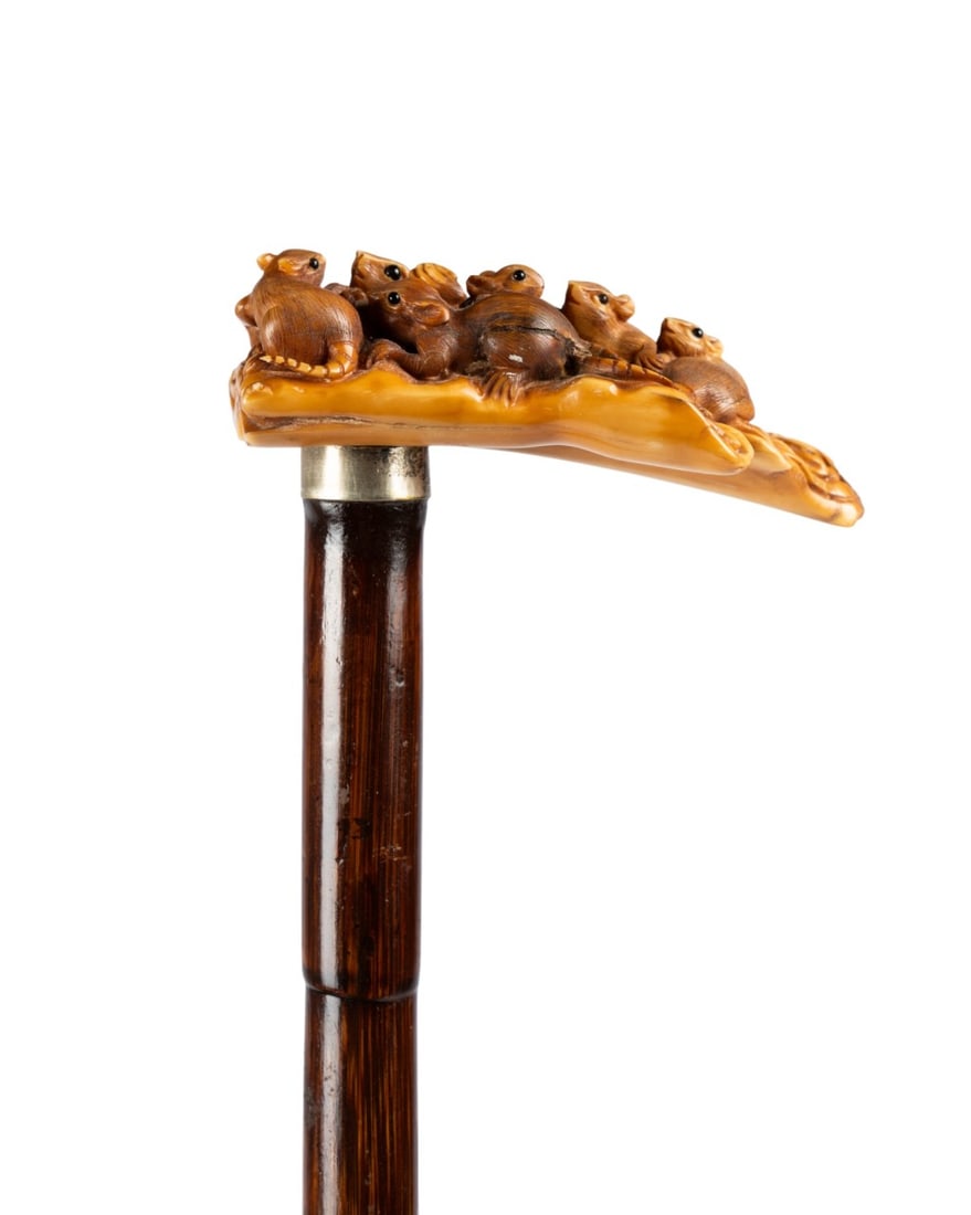 19TH C. JAPANESE CARVED MICE HANDLE WALKING CANE: Japanese, circa 1890. Walking cane with highly carved relief handle of mother mouse and six offspring with black eyes, silver collar, stepped partridge wood shaft, and brass ferrule. Approximate measu