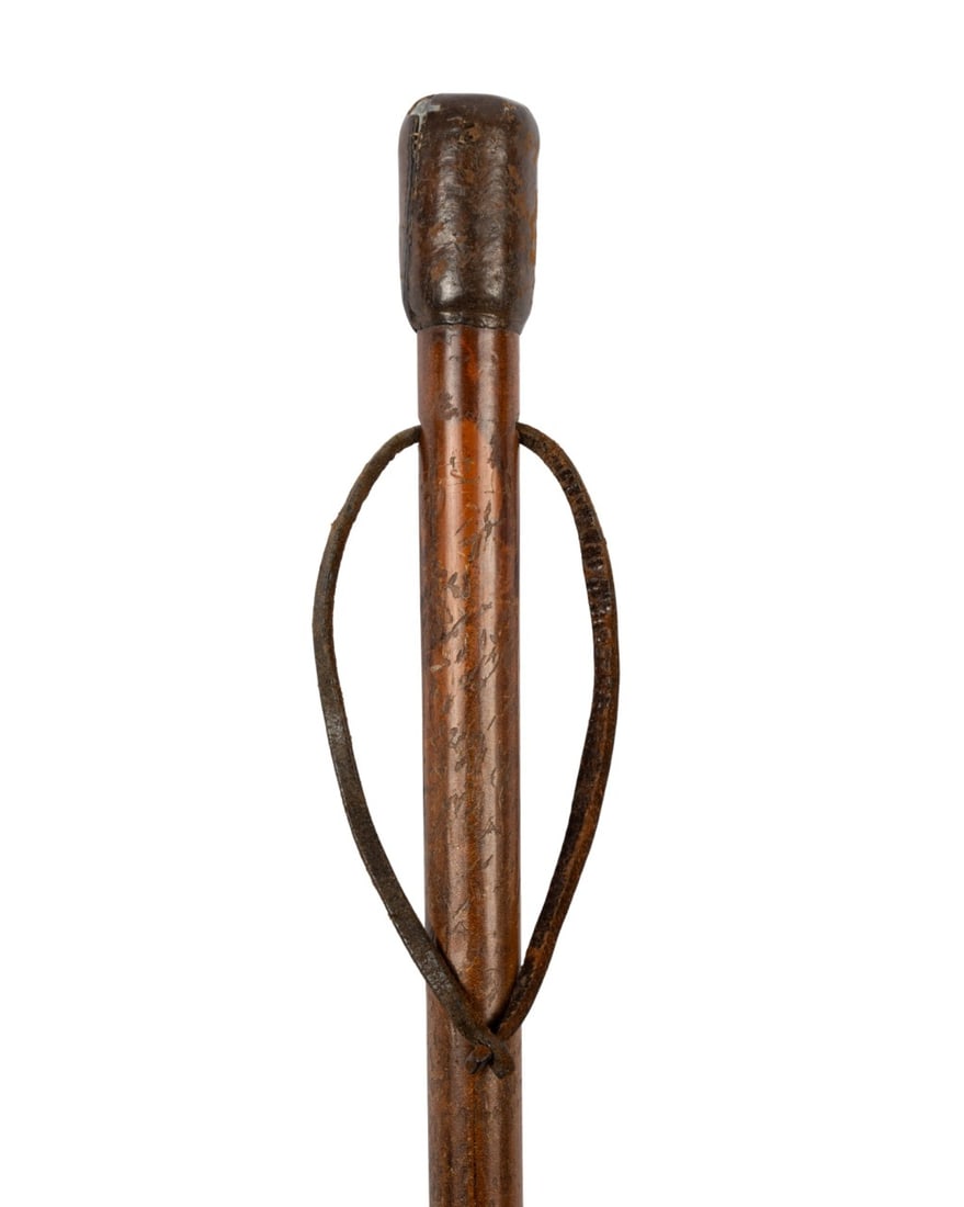 ENGLISH HEAVY LEAD HANDLE WALKING CANE, C. 1900: English, circa 1900. Weapon cane with heavy lead handle covered in cowhide, Malacca shaft with well-defined grain, eyelet below handle for leather strap, long horn ferrule, designed as a defensive can