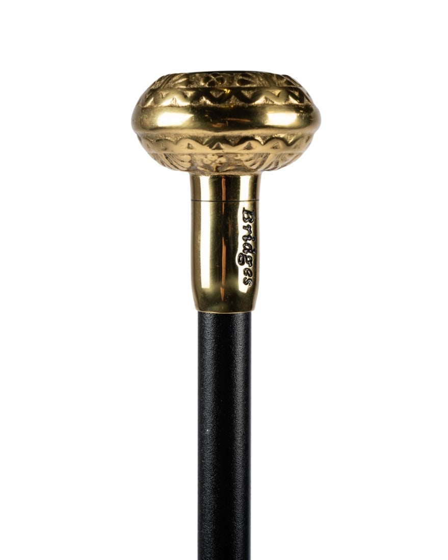 ATLANTA 1996 OLYMPICS SOUVENIR CANE: American, 1996. Souvenir cane by Briggs with solid brass knob handle bearing the Atlanta 1996 logo, brass collar, black enameled metal shaft, and bronze ferrule. Approximate measurements: length: