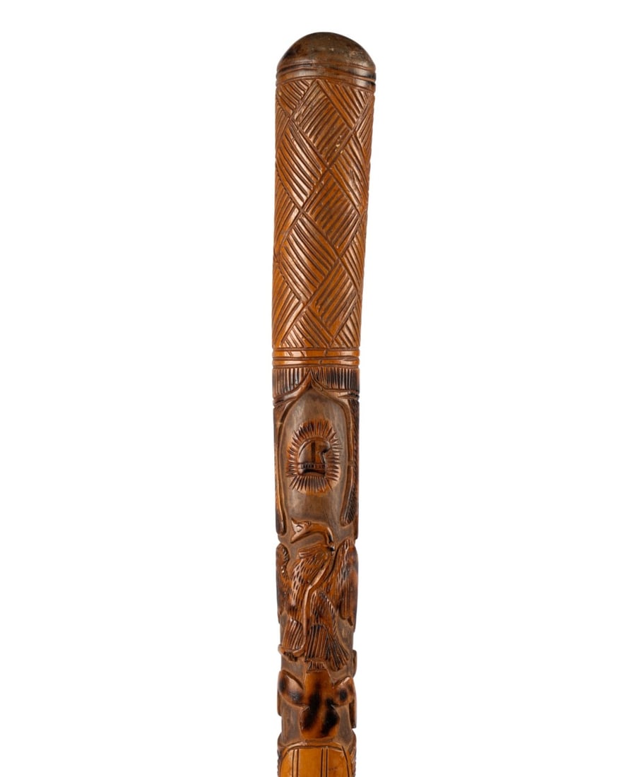 ECUADORIAN CARVED WALKING STICK: Ecuadorian, circa 1970. Walking cane with carved handle in basket weave design, carved shaft with floral and figural motifs, without ferrule. Approximate measurements: length: 35.5"