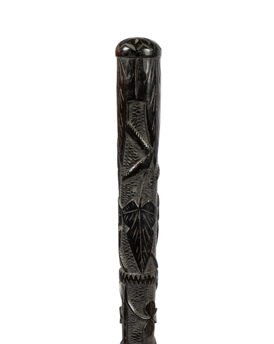 IRISH BOGWOOD WALKING CANE, C. 1870: Irish, circa 1875. Oak bogwood walking cane with handle carved with shamrocks and leaves above central carved snake, silver collar with decorative buckle and engraved monogram "B.T.", and plain shaft