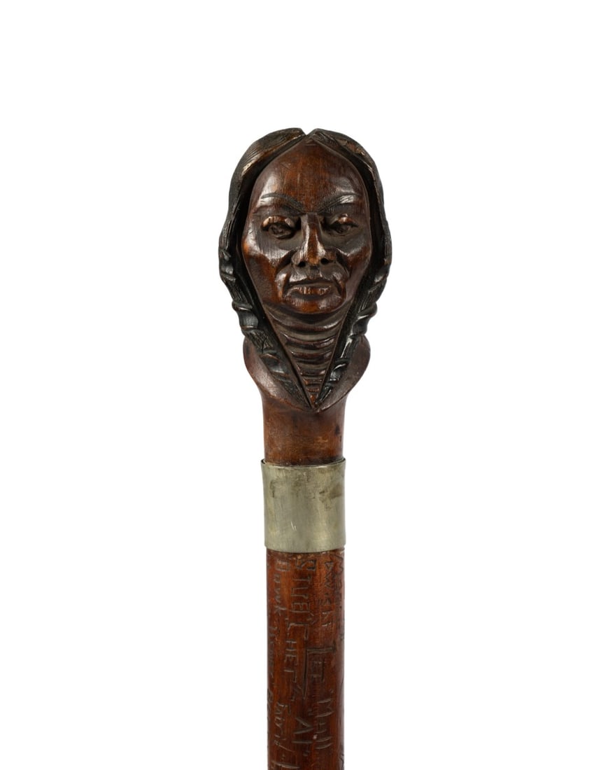 DARTMOUTH COLLEGE SENIOR CANE, 1909: American, 1909. Dartmouth College walking cane with carved wood bust of Native American at handle, silver collar, back of collar carved "H.A. Dykeman", fruitwood shaft carved with names of the senior