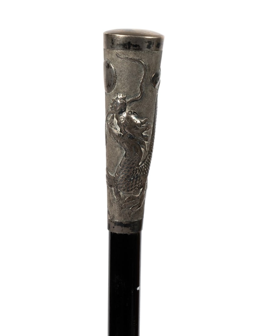 19TH C. STERLING SILVER DRAGON MOUNT CANE: Continental, circa 1890. Walking cane with sterling silver dragon mounted on ebonized wood shaft, circular plate below handle engraved "R.J.R.", and without ferrule. Approximate measurements: